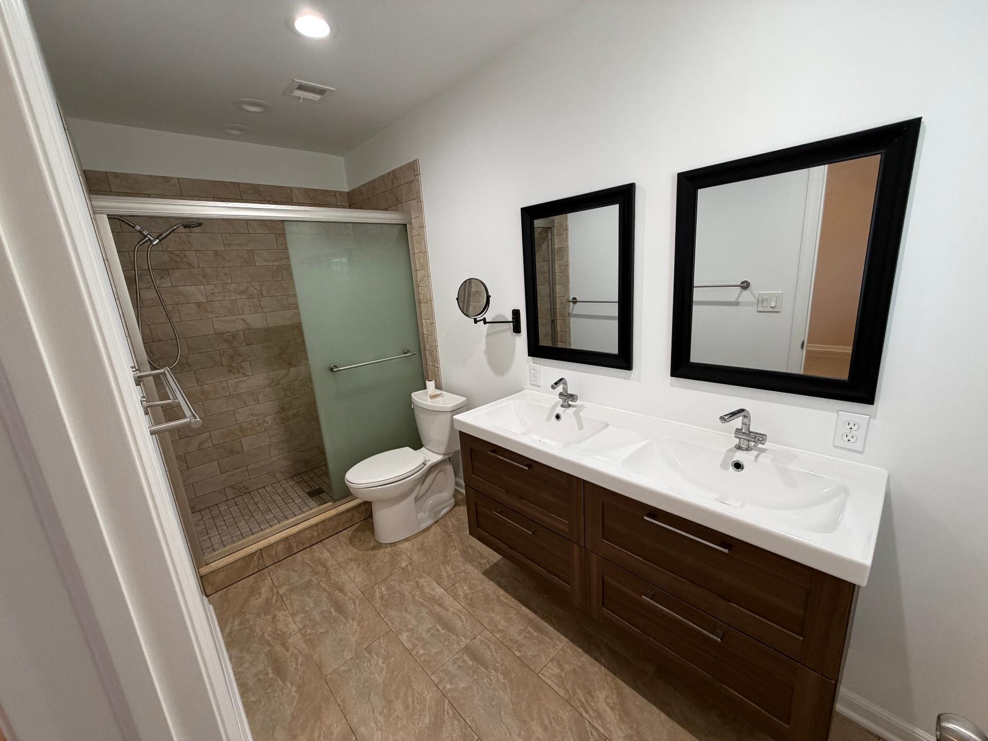 Primary bathroom with double vanity and walk-in shower