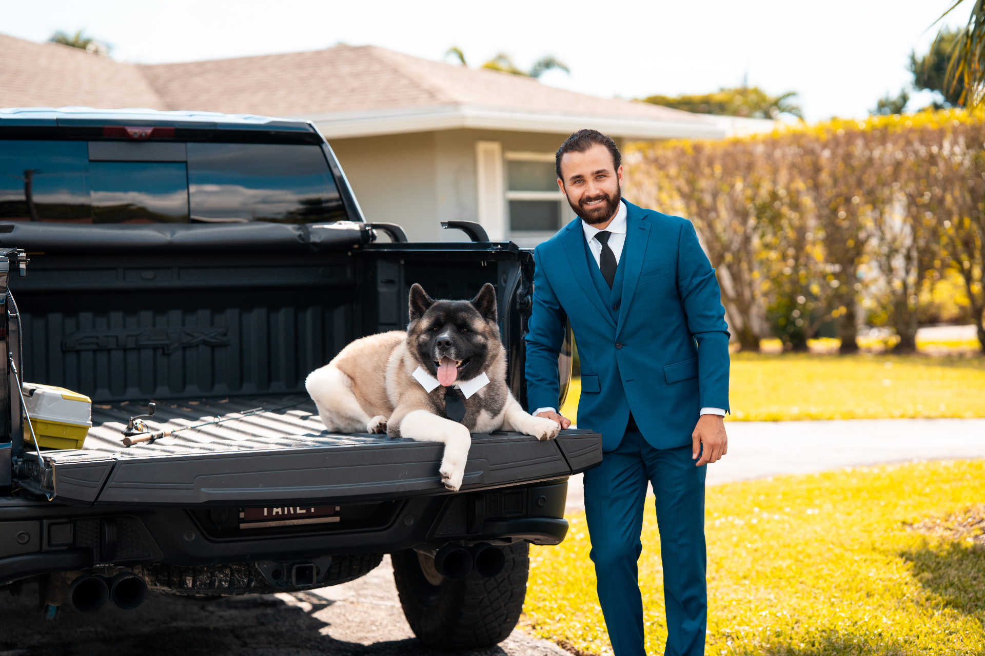 Jacob Goodman with his Akita beside his truck